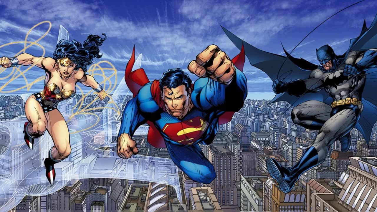 Comic versions of Superman, Batman, and Wonder Woman soaring through the sky with dynamic poses against a bright, cloudy background.