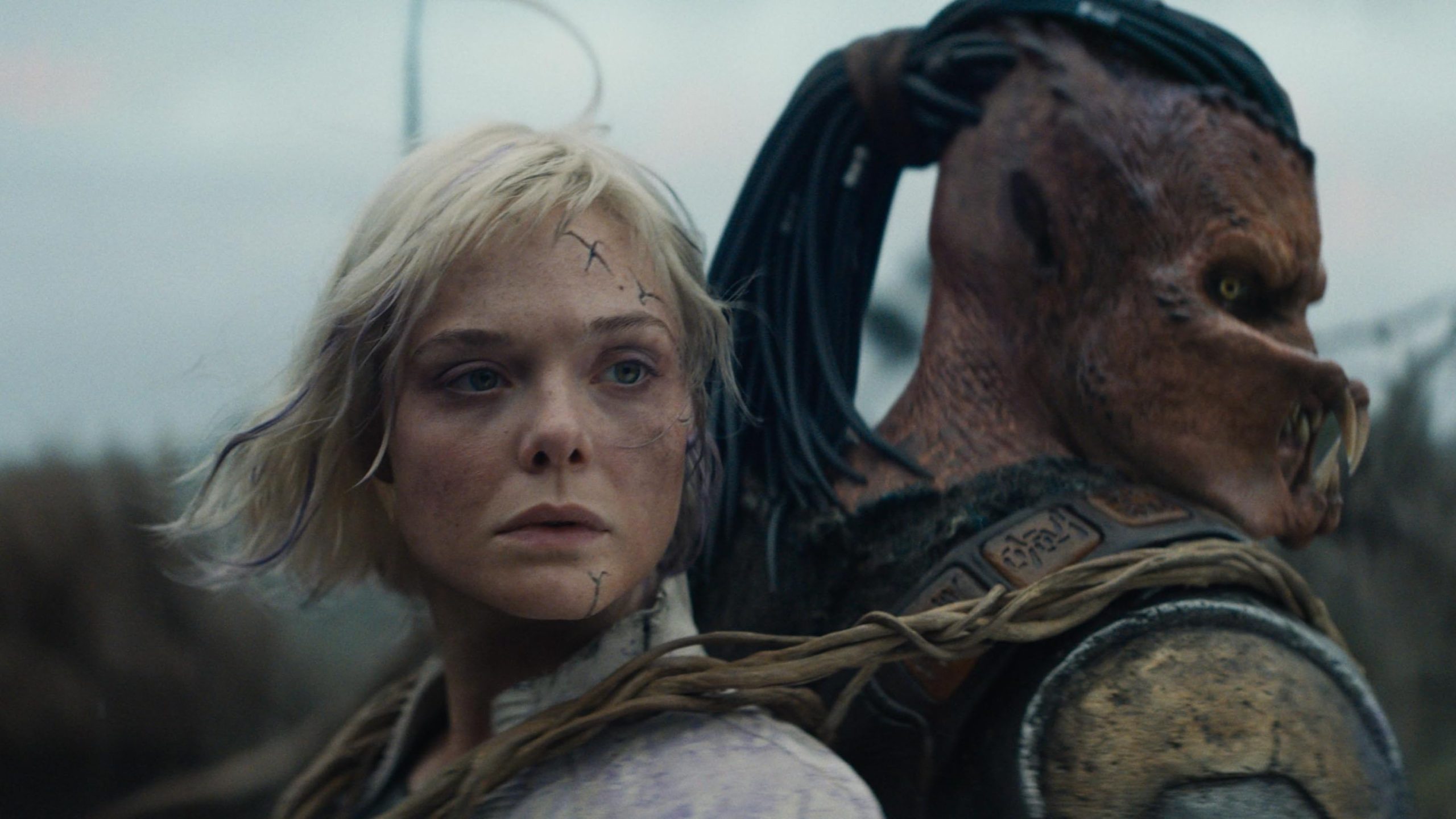 Dimitrius Schuster-Koloamatangi and Elle Fanning in Predator: Badlands