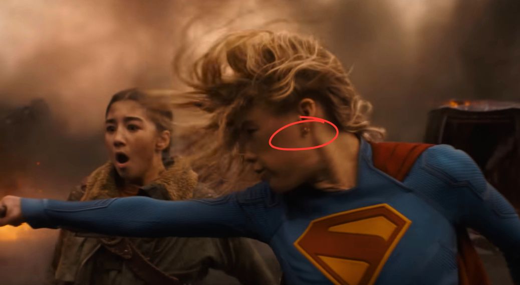 Why does Milly Alcock's Supergirl have ear piercings